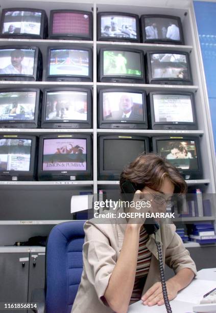 Al-Jazeera correspondent Dima al-Khatib takes a phone call at the satellite channel's headquarters in the Qatari capital Doha 10 October 2001....