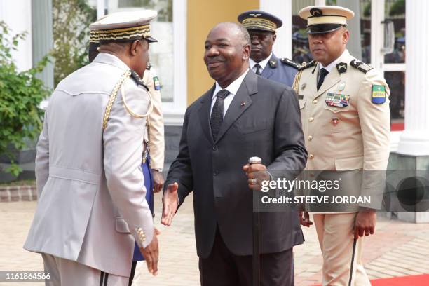 Gabon President Ali Bongo shakes hands at a ceremony in Libreville on August 16, 2019 at the Mausoleum of the Country First President during a wreath...