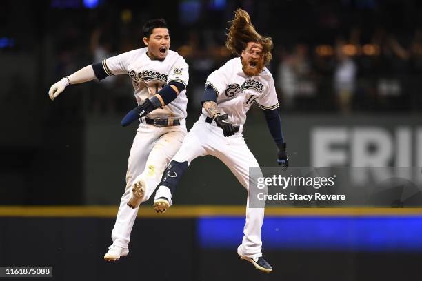 Ben Gamel of the Milwaukee Brewers celebrates with Keston Hiura after hitting the game winning RBI against the San Francisco Giants during the ninth...
