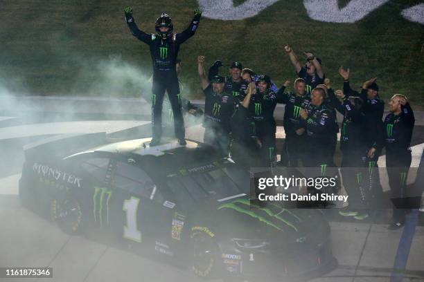 Kurt Busch, driver of the Monster Energy Chevrolet, celebrates with his crew members after winning the Monster Energy NASCAR Cup Series Quaker State...