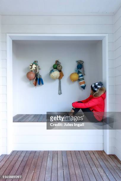 girl sitting along in a nook - nook architecture stockfoto's en -beelden