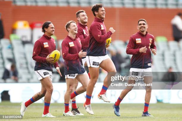 Lions players warm up during the round 16 AFL match between the Port Adelaide Power and the Brisbane Lions at Adelaide Oval on July 14, 2019 in...