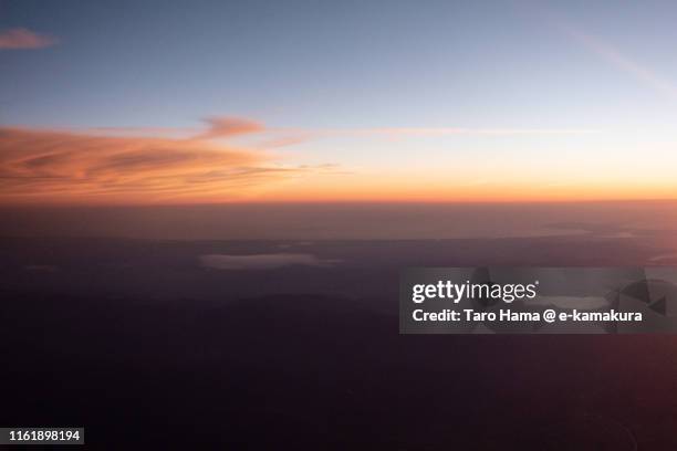 lake tazawa and sea of japan in japan sunset time aerial view from airplane - tazawa stock pictures, royalty-free photos & images