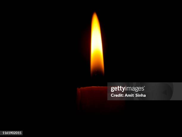 a candle glowing in the dark - candlelight stock pictures, royalty-free photos & images