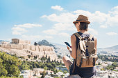 Woman using smart phone on vacations in Athens