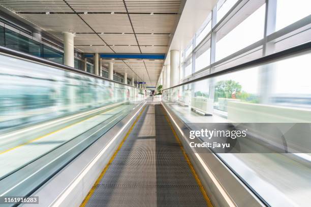 moving walkway in airport/station - moving walkway airport stock pictures, royalty-free photos & images