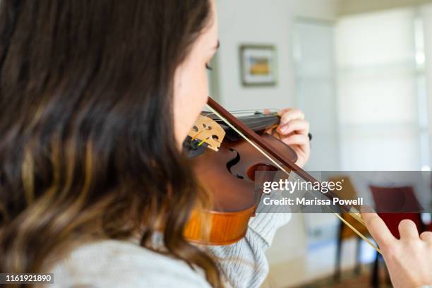 teenage girl plays the violin - violin stock pictures, royalty-free photos & images