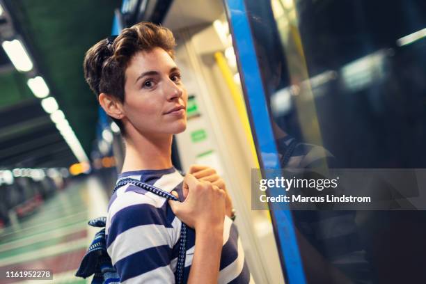 woman boarding a subway train - stockholm metro stock pictures, royalty-free photos & images