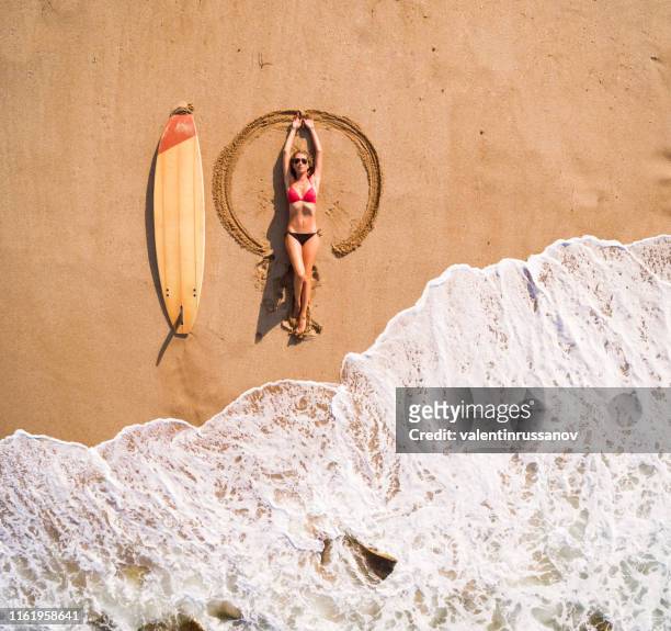 aerial view of a surfer girl resting on a beach - angel island stock pictures, royalty-free photos & images