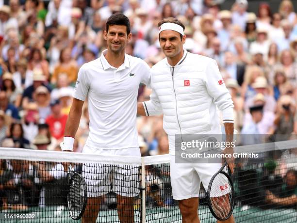 Novak Djokovic of Serbia and Roger Federer of Switzerland pose for a photo at the net prior to their Men's Singles final during Day thirteen of The...