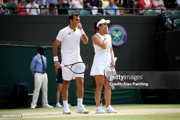 Ivan Dodig of Croatia and Latisha Chan of Chinese Taipei talk tactics in their Mixed Doubles final against Robert Lindstedt of Sweden and Jelena...