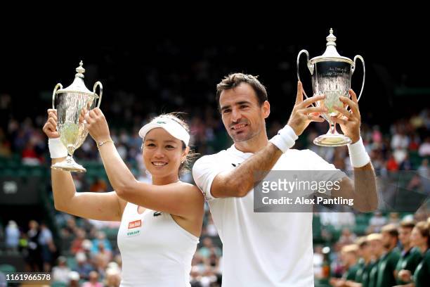 Ivan Dodig of Croatia and Latisha Chan of Chinese Taipei pose with the trophy following victory in their Mixed Doubles final against Robert Lindstedt...