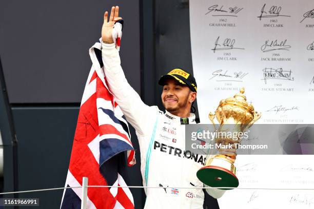 Race winner Lewis Hamilton of Great Britain and Mercedes GP celebrates on the podium during the F1 Grand Prix of Great Britain at Silverstone on July...