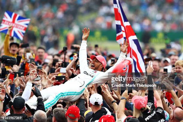 Race winner Lewis Hamilton of Great Britain and Mercedes GP celebrates with fans after the F1 Grand Prix of Great Britain at Silverstone on July 14,...