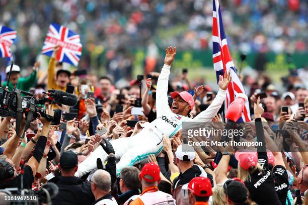 Race winner Lewis Hamilton of Great Britain and Mercedes GP celebrates with fans after the F1 Grand Prix of Great Britain at Silverstone on July 14,...