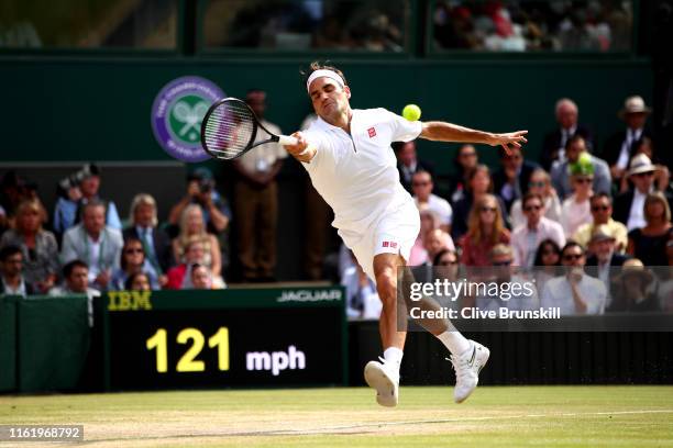 Roger Federer of Switzerland stretches to play a forehand in his Men's Singles final against Novak Djokovic of Serbia during Day thirteen of The...
