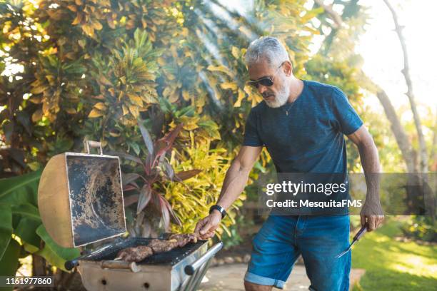 brazilian churrasco outdoors - barbecue man stock pictures, royalty-free photos & images