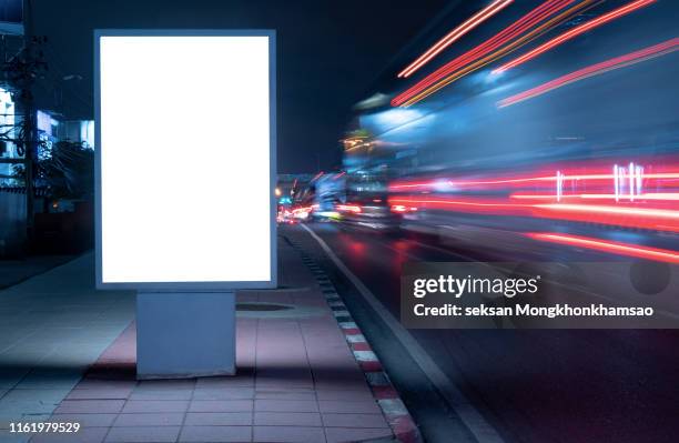 blank billboard on city street at night. outdoor advertising - panneau commercial photos et images de collection