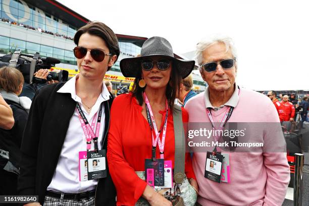 Actors Michael Douglas and Catherine Zeta-Jones and their son Dylan Douglas pose for a photo on the grid before the F1 Grand Prix of Great Britain at...