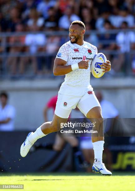 Dan Norton of England looks behind him as he makes a break to score a try during the Cup Final match between France and England on day two of the...