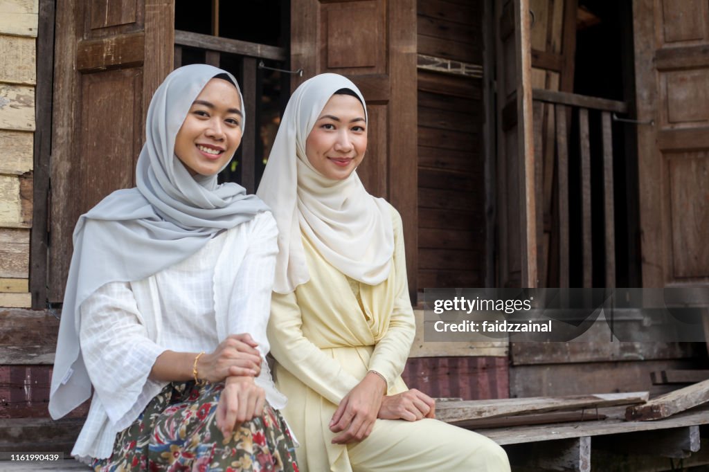 Two Young Malay Muslim Women Sitting Together