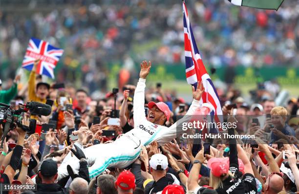 Race winner Lewis Hamilton of Great Britain and Mercedes GP celebrates with fans after the F1 Grand Prix of Great Britain at Silverstone on July 14,...