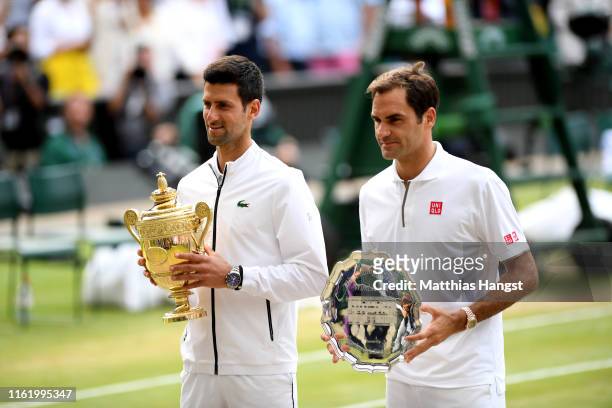 Novak Djokovic of Serbia and Roger Federer of Switzerland pose for a photo with their trophies after Men's Singles final against Roger Federer of...