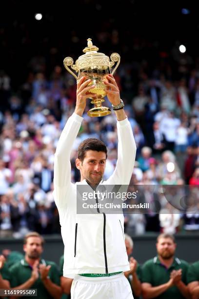 Novak Djokovic of Serbia poses for a photo with the trophy after winning his Men's Singles final against Roger Federer of Switzerland during Day...