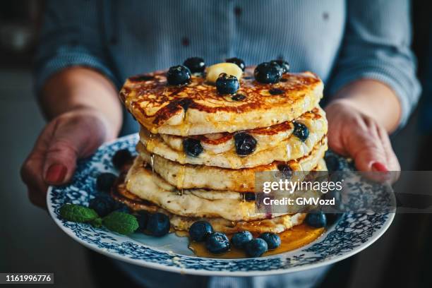 stack of pancakes with maple syrup and fresh blueberries - ready to eat stock pictures, royalty-free photos & images