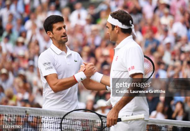 Novak Djokovic of Serbia shakes hands with Roger Federer of Switzerland at the net following victory in his Men's Singles final during Day thirteen...