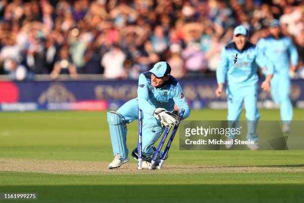 Jos Buttler of England runs out Martin Guptill of New Zealand to seal victory for England during the Final of the ICC Cricket World Cup 2019 between...