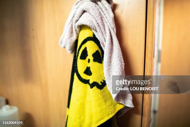This illustration shows a towel with the radioactivity warning sign aboard the Rainbow Warrior III ship, docked in the port of Cherbourg,...