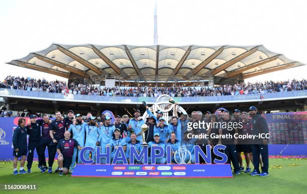 The England side pose as they celebrate after winning the Cricket World Cup during the Final of the ICC Cricket World Cup 2019 between New Zealand...
