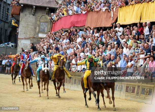 Rider Andrea Mari known as Brio on Bruco Contrada's team horse Schietta competes with riderless Selva Contrada team horse Remorex during the...