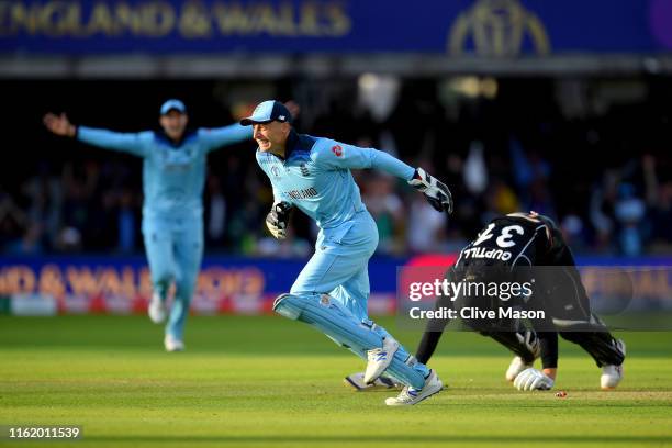 Jos Buttler of England celebrates running out Martin Guptill of New Zealand to seal victory for England during the Final of the ICC Cricket World Cup...