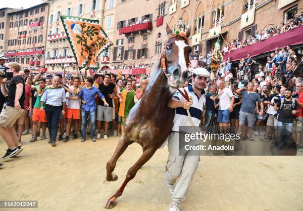 Rider performs with a horse to celebrate the victory of the famous Palio Di Siena horse race that is held twice each year, on July 2 and August 16,...
