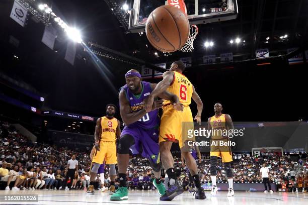 Reggie Evans of 3 Headed Monsters competes for the ball with Josh Smith of Bivouac during week four of the BIG3 three-on-three basketball league at...