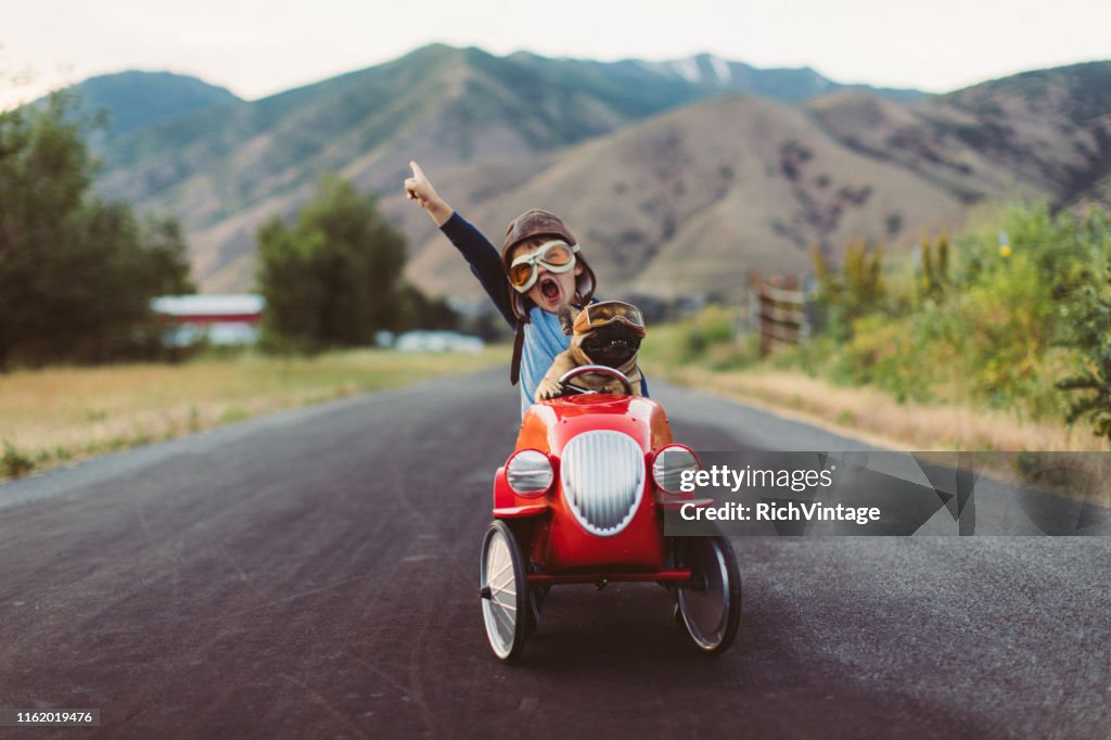 Boy and Dog in Toy Racing Car