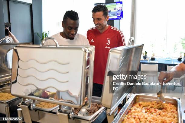 Juventus players Blaise Matuidi and Gianluigi Buffon joke during the lunch at J Hotel on July 14, 2019 in Turin, Italy.