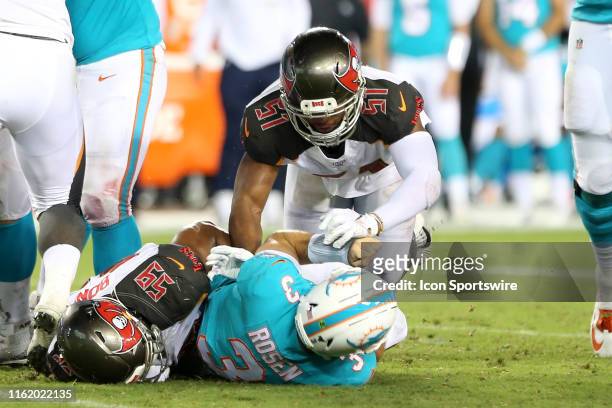 Devante Bond and Kevin Minter of the Bucs combine to bring down Dolphins quarterback Josh Rosen during the preseason game between the Miami Dolphins...