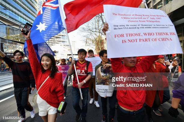 Pro-China activists march on the streets of Sydney on August 17 as they rally against ongoing protests in Hong Kong. - Hundreds of activists bearing...