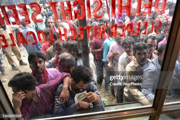 Non-Locals wait in line to buy the tickets as they wait for the vehicles to leave the Kashmir valley in Srinagar, Indian Administered Kashmir on 07...