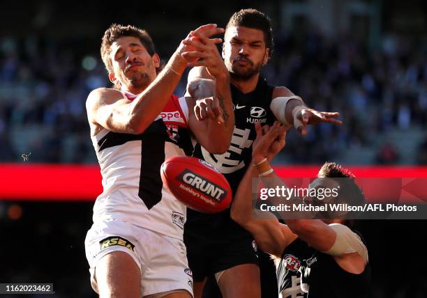 Ben Long of the Saints, Sam Petrevski-Seton of the Blues and Dale Thomas of the Blues compete for the ball during the 2019 AFL round 22 match between...