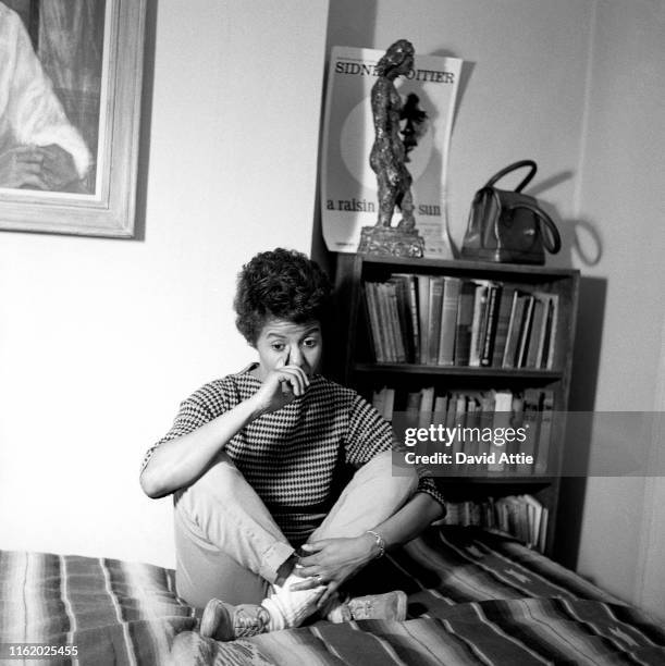 April 1959: Writer and playwright Lorraine Hansberry poses for a portrait in her apartment at 337 Bleecker Street in April, 1959 in New York City,...