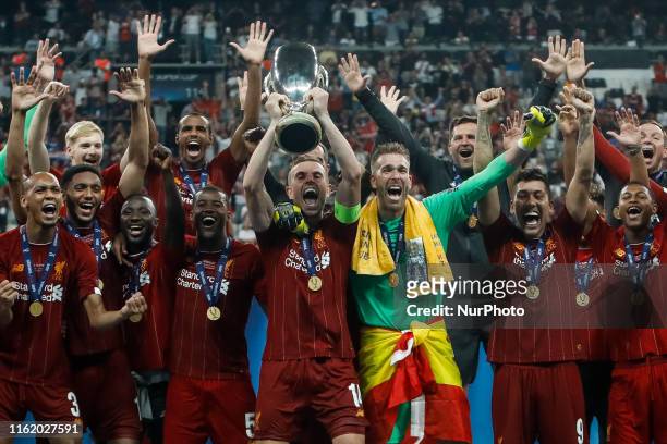 Liverpool players celebrate with the trophy during the UEFA Super Cup match between Liverpool and Chelsea on August 14, 2019 at Besiktas Park in...