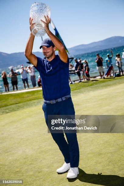 Tony Romo holds the trophy for winning the 30th Annual American Century Championship at Edgewood Tahoe Golf Course on July 14, 2019 in Stateline,...