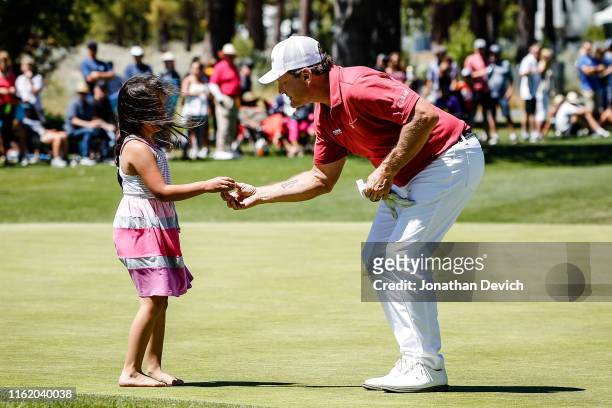Jeremy Roenick gives his golf ball to a little girl after completing the final round of the American Century Championship at Edgewood Tahoe Golf...