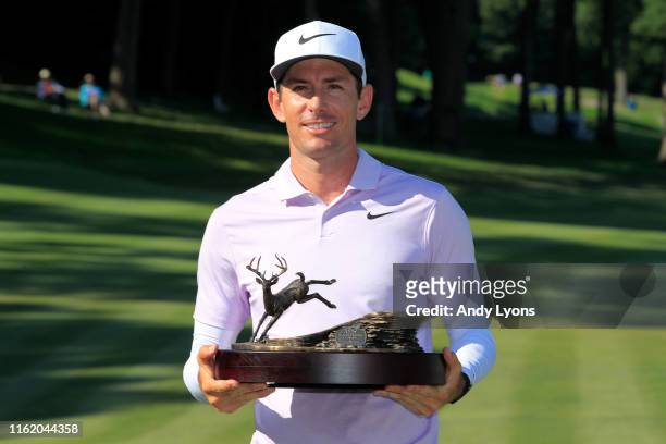 Dylan Frittelli of South Africa celebrates with the trophy after winning the John Deere Classic at TPC Deere Run on July 14, 2019 in Silvis, Illinois.