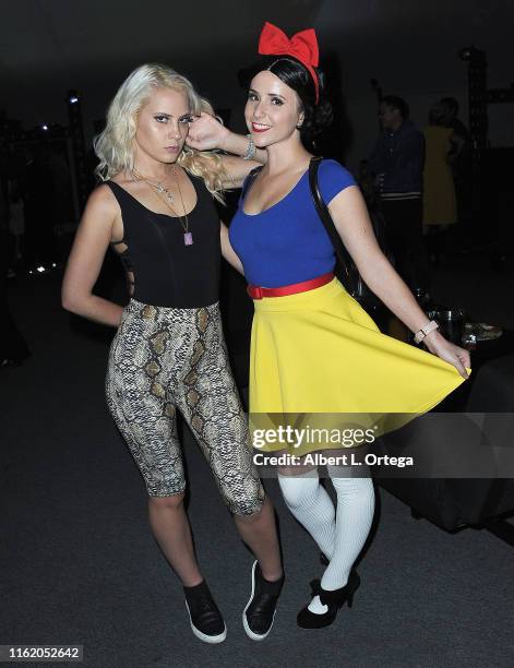 Kristi Tucker poses with Snow White at InfoList Pre-Comic-Con Bash at Wisdome Immersive Art Park on July 11, 2019 in Los Angeles, California.