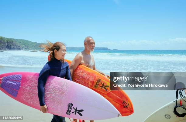 senior couple walking beach - japanese senior couple bildbanksfoton och bilder